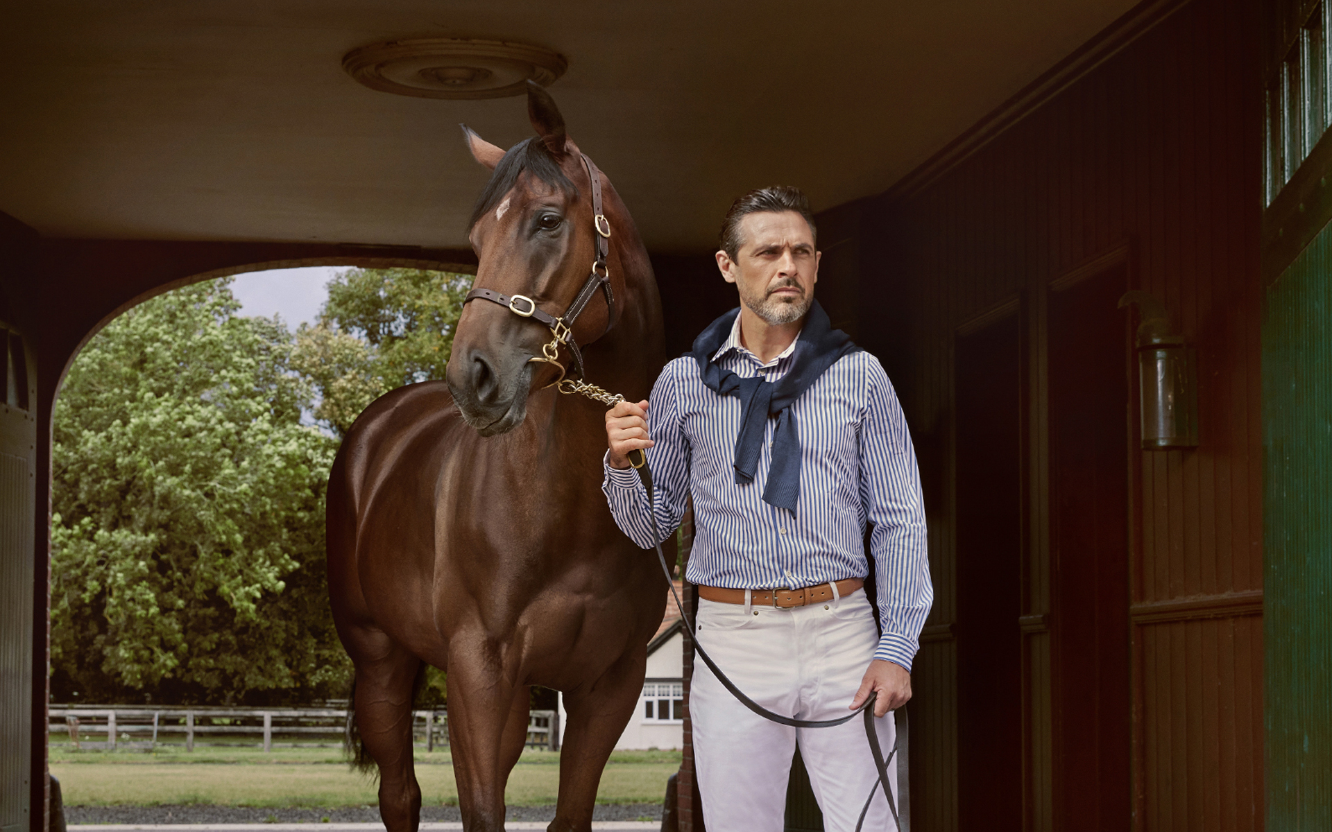 advertising fashion photo shoot for Paul brown clothing male model with horse at egerton house newmarket suffolk